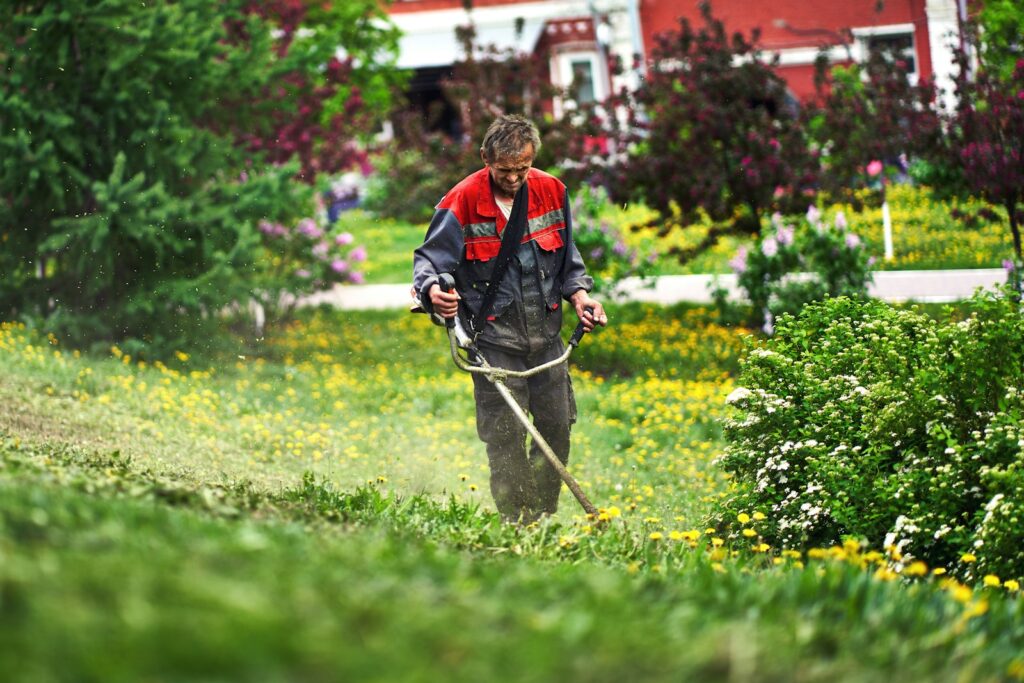 a man is mowing the grass in the yard